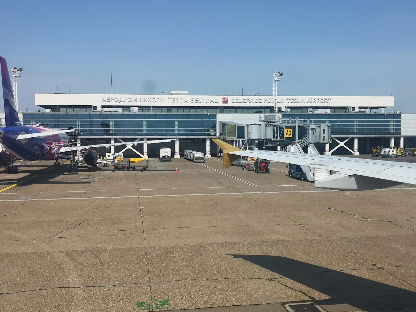 Belgrade Nikola Tesla Airport terminal with aircraft at gates